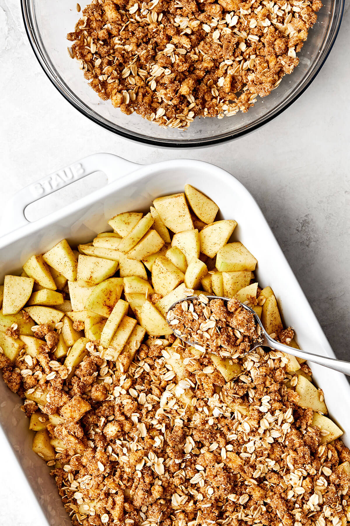 Adding oat crumble on top of apple filling.