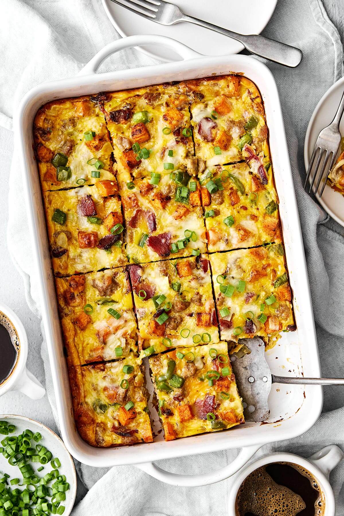 This is the best breakfast casserole loaded with bacon, sausage, sweet potatoes, and plenty of veggies. Plus, it's always a crowd favorite! A baking dish with breakfast casserole.