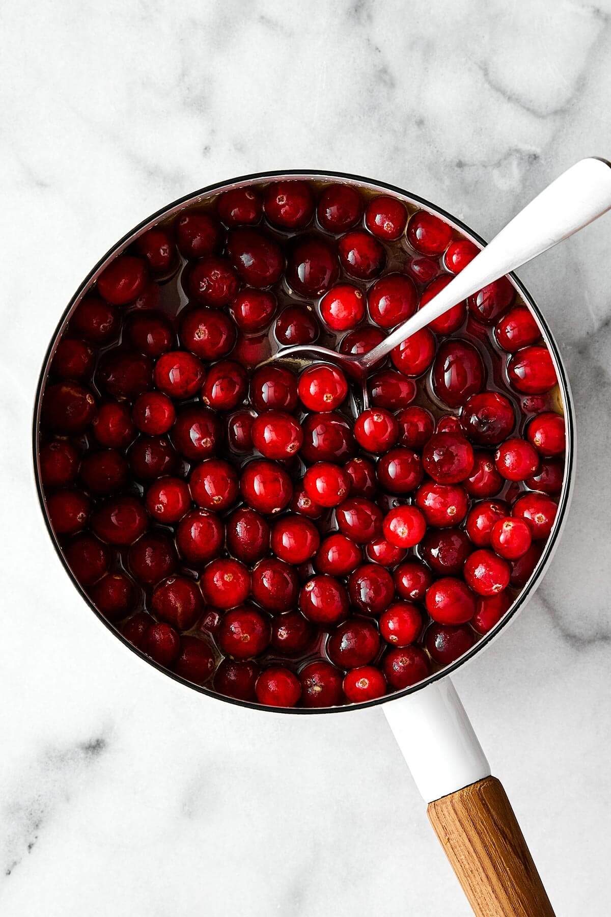 Cooking cranberries in a pot.