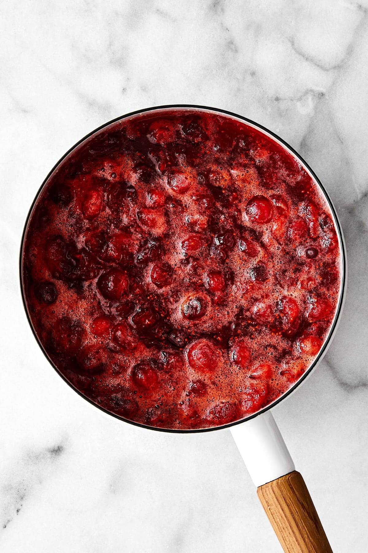 Boiling cranberry sauce in a pot.