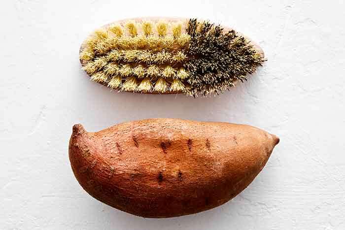 Scrubbing sweet potato.