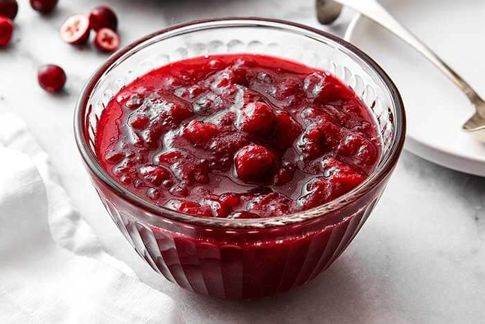 Cranberry sauce in a glass bowl.