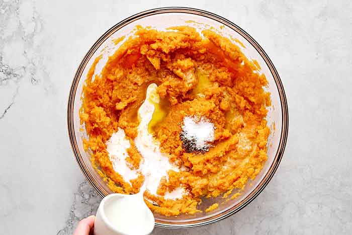 Mixing mashed sweet potatoes.