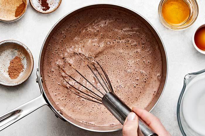 Mexican hot chocolate whisked in a pot.