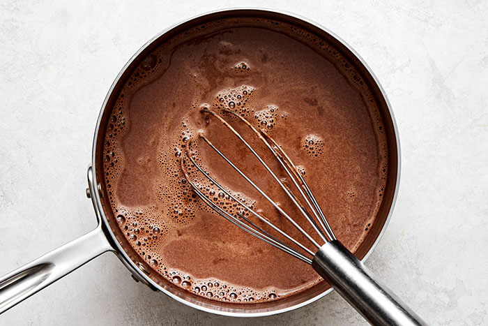 Mexican hot chocolate in a steel pot.