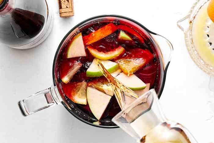 Pouring Brandy into sangria.