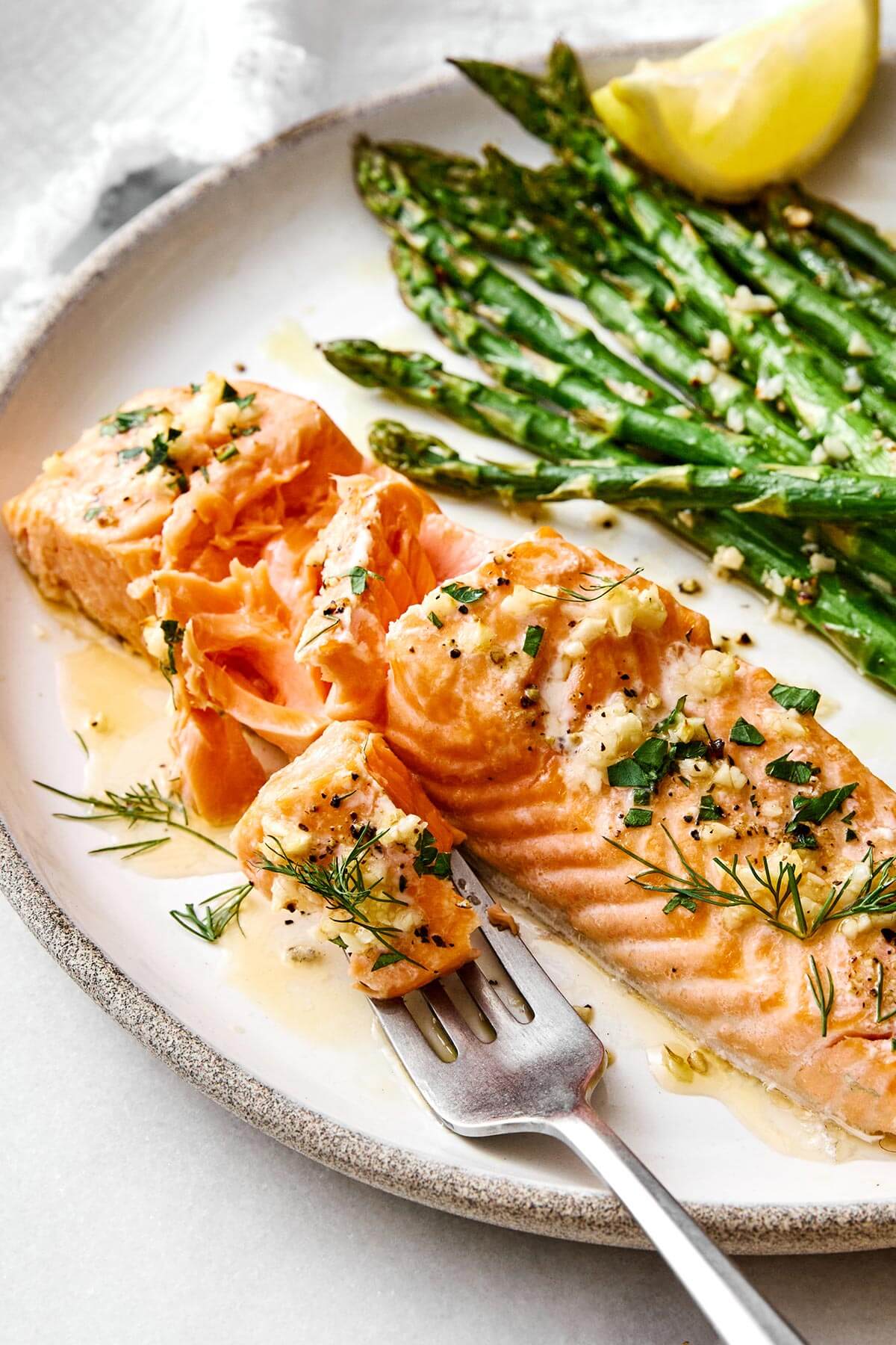Baked salmon with asparagus on a plate.