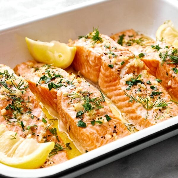 A white tray of lemon garlic baked salmon.