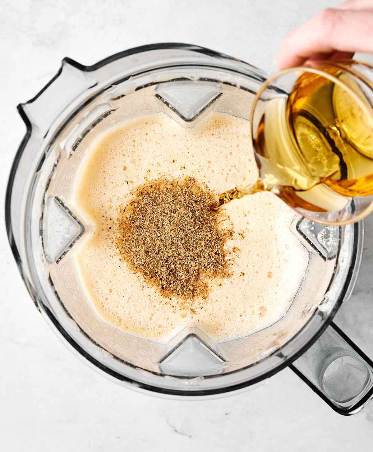 Step two of making eggnog: blending in alcohol.