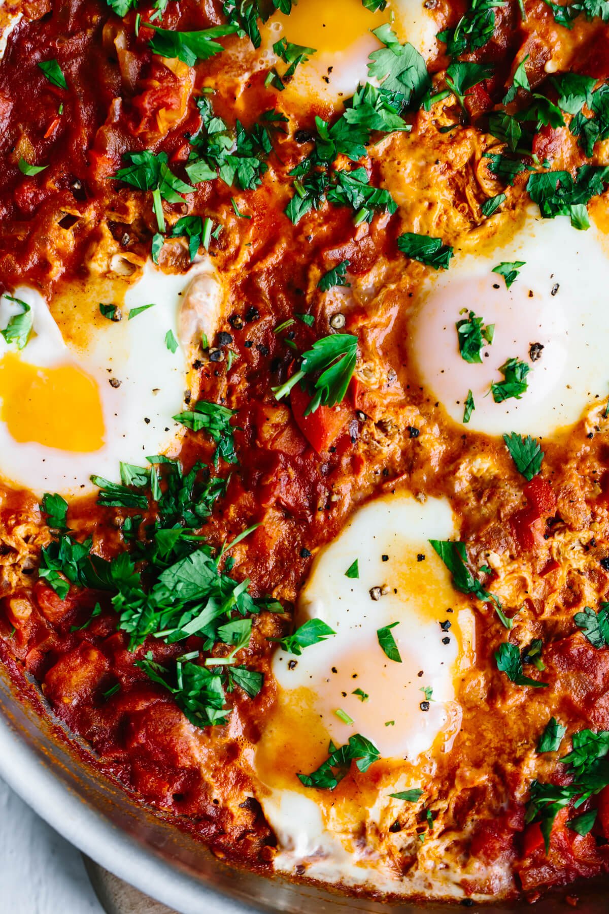 Close up photo of shakshuka in a pan.