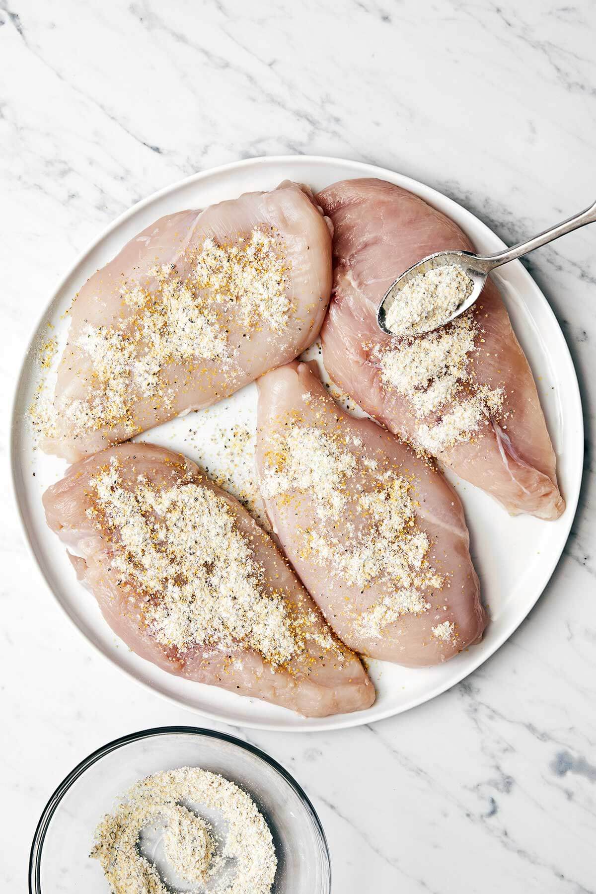 This lemon pepper chicken dinner is perfect for busy weeknights. It's bright and tangy with a golden crust and topped with a garlic butter sauce. Adding lemon pepper seasoning to the chicken.