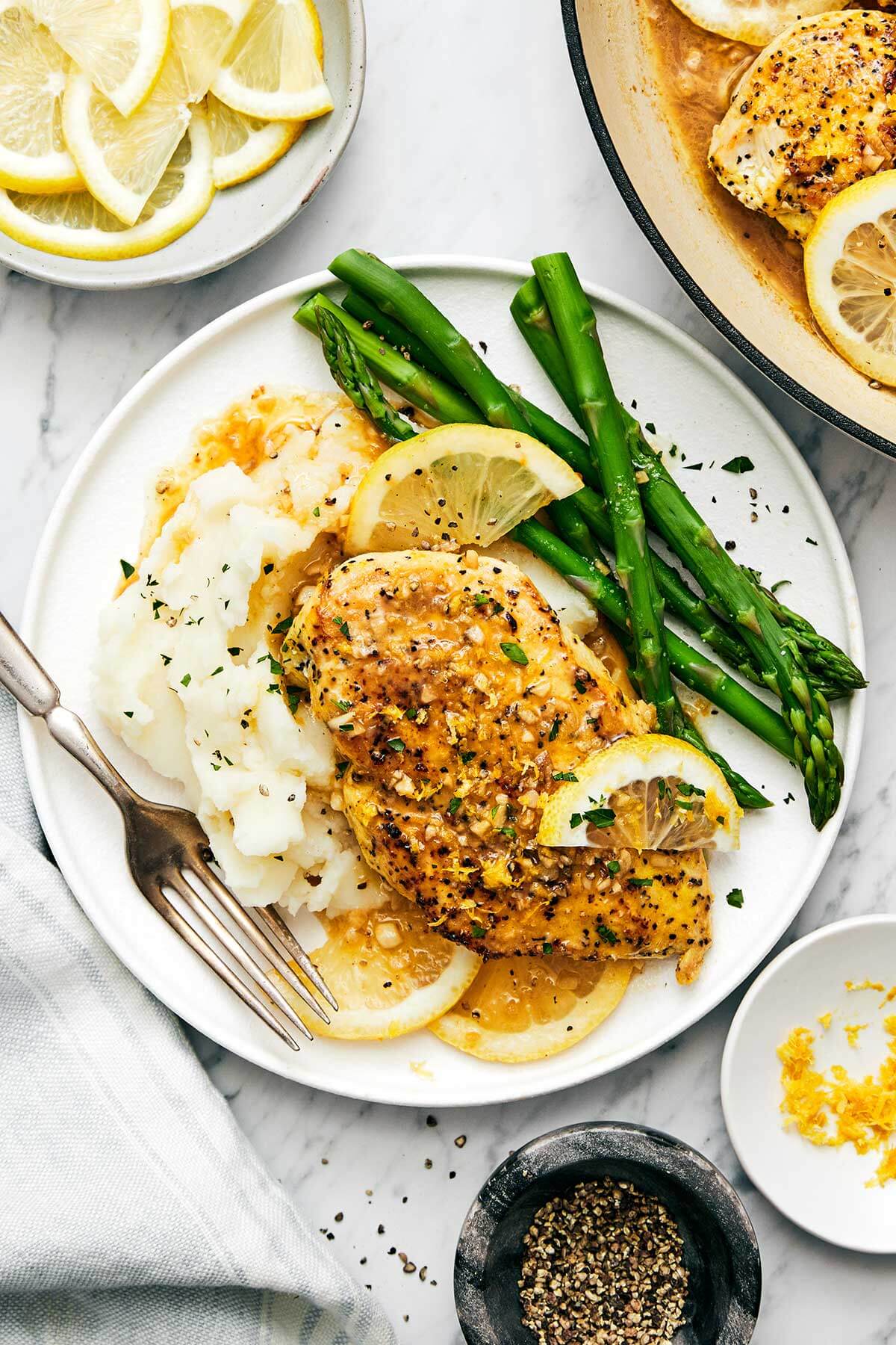 This lemon pepper chicken dinner is perfect for busy weeknights. It's bright and tangy with a golden crust and topped with a garlic butter sauce. Lemon pepper chicken with mashed potatoes.