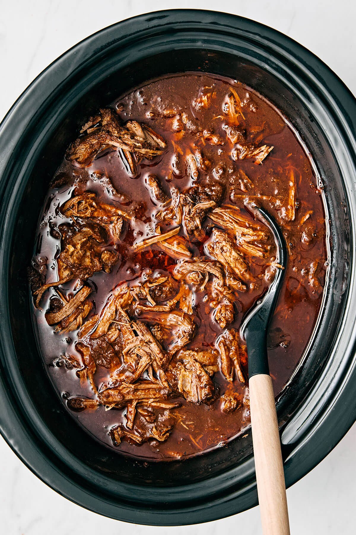 Beef birria in a slow cooker.