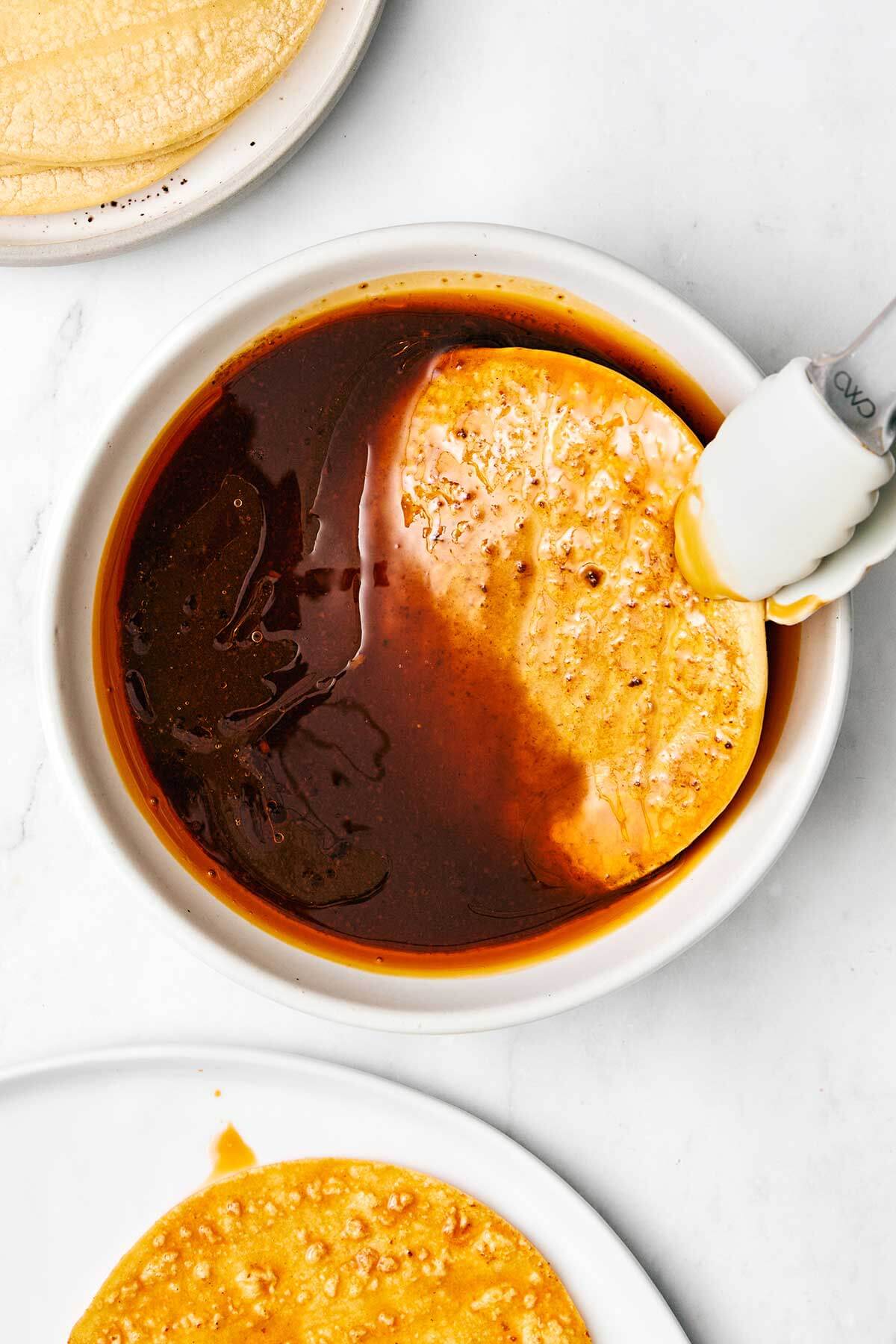 Dipping tortilla in consomme.