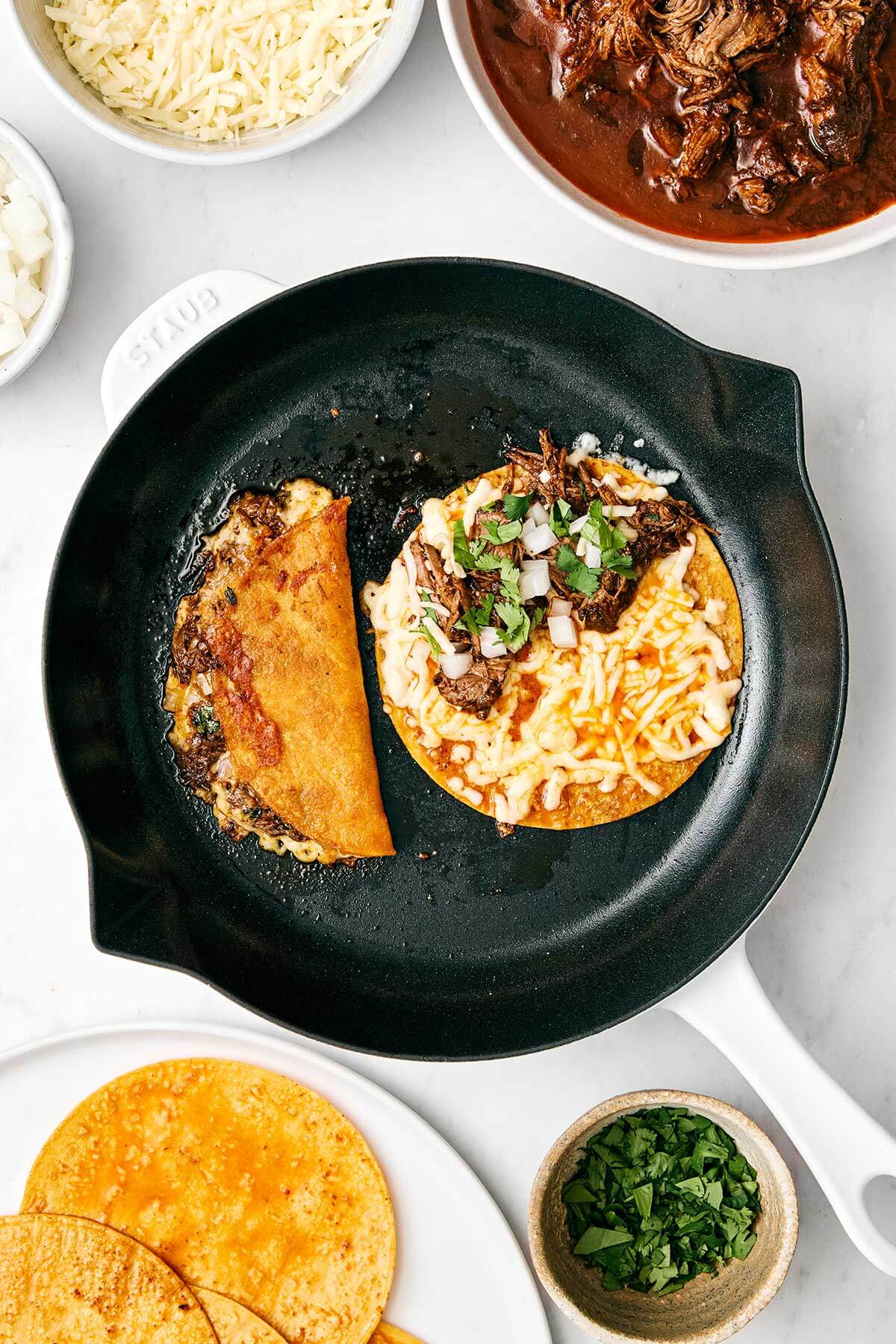 Pan frying birria tacos in a skillet.