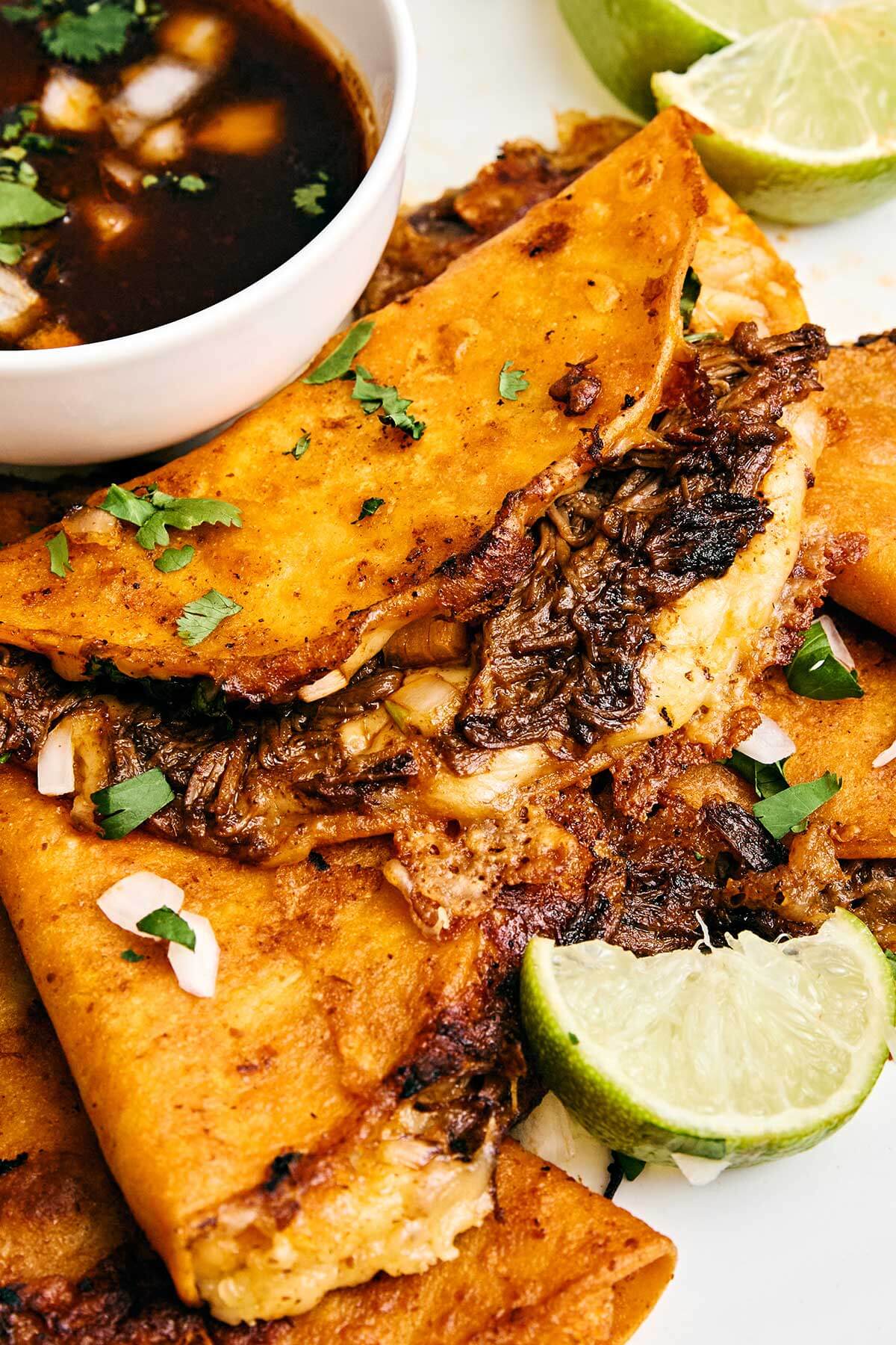 Beef birria tacos with consomme.