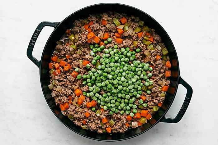 Cooked meat and veggies in a skillet.