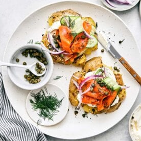 Smashed potatoes with lox ingredients on top.