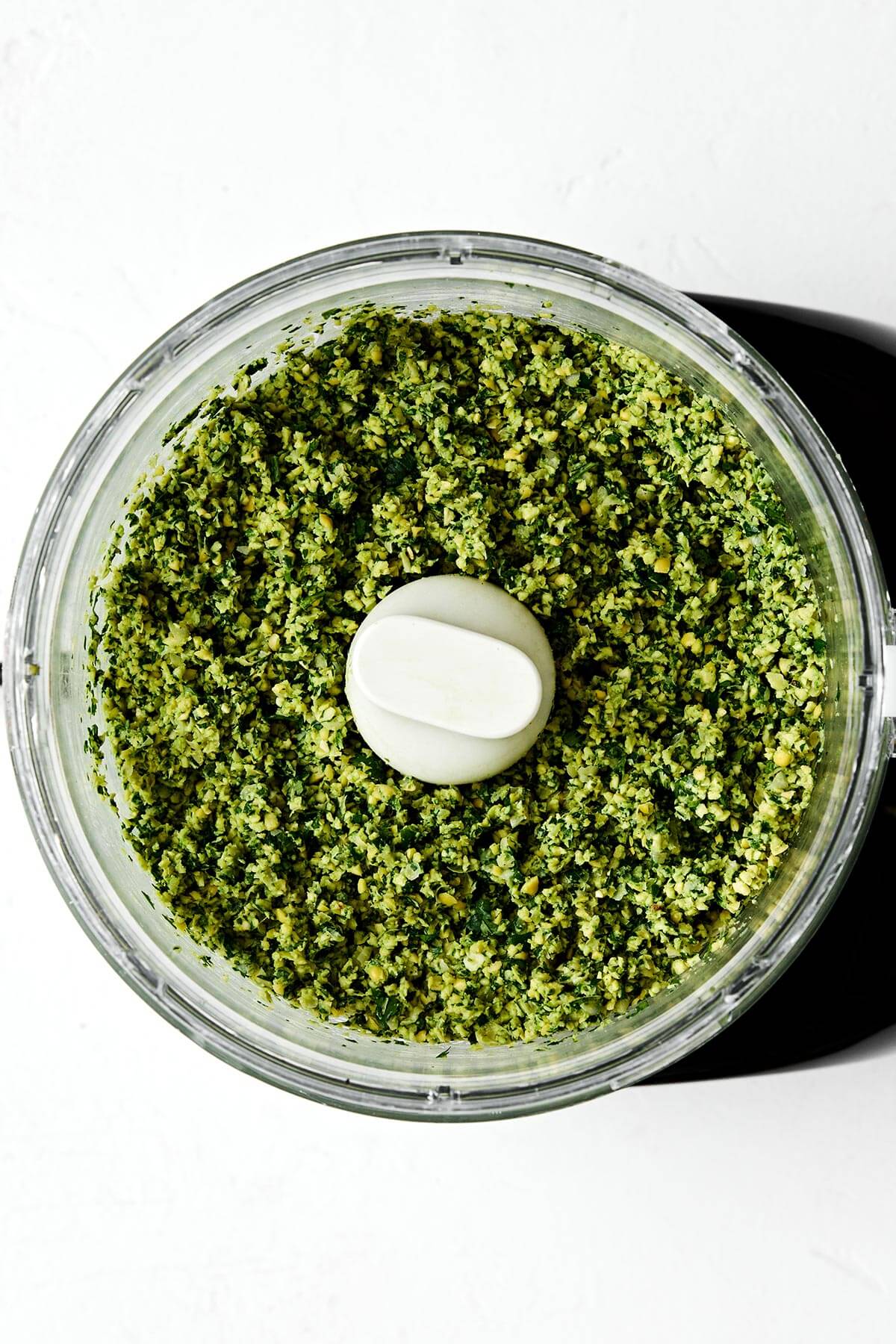 Falafel are delicious balls of chickpea and herb goodness in Middle Eastern cooking. They're naturally vegan and vegetarian, and great in wraps, pitas, sandwiches and salads. You can make fried falafel and baked falafel - I've got instructions for both! Blending falafel in a food processor.