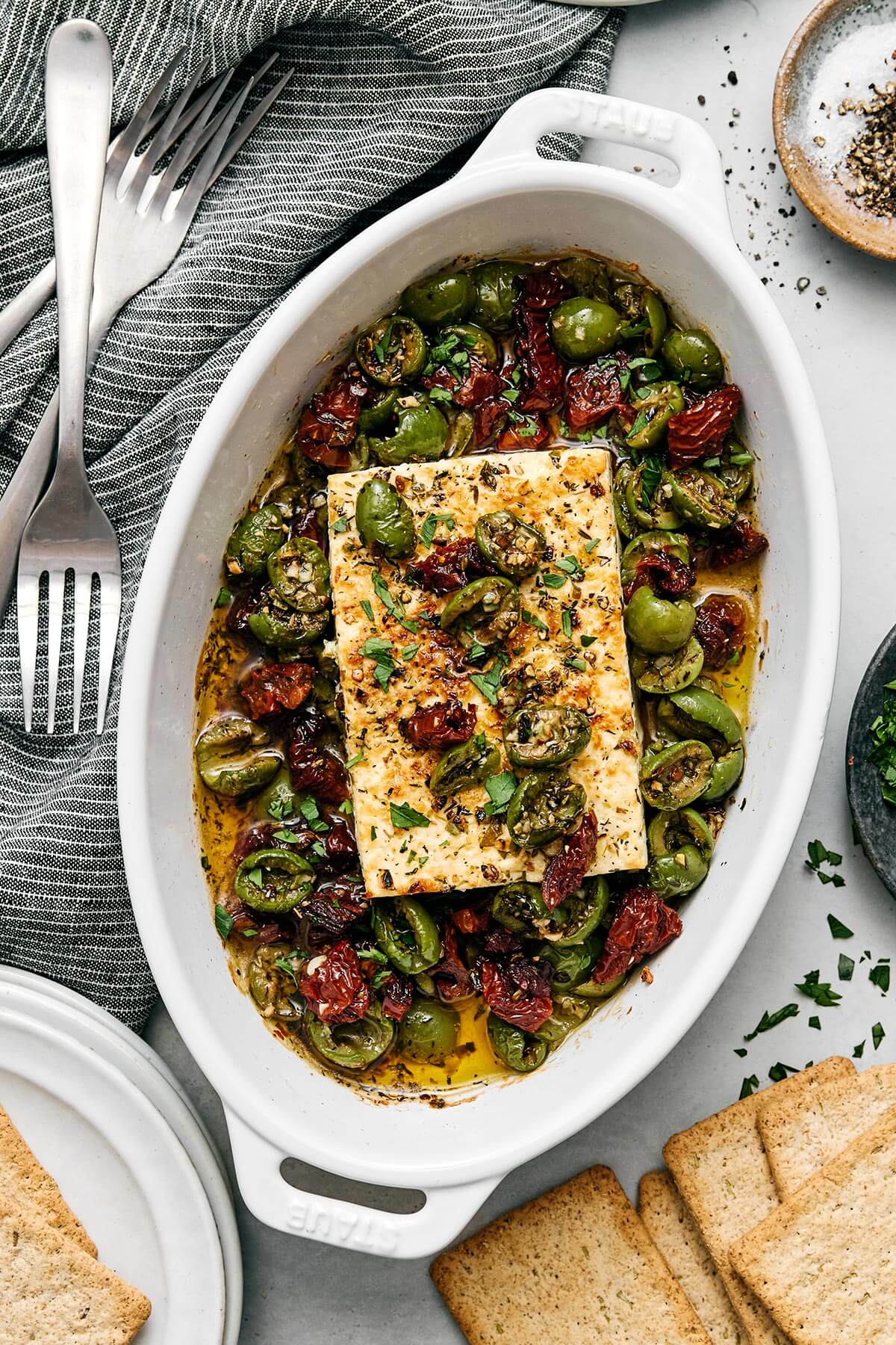 This Mediterranean baked feta with olives and sund-dried tomatoes is officially my signature appetizer for dinner parties! It's so easy and great for any holiday. Mediterranean baked feta.