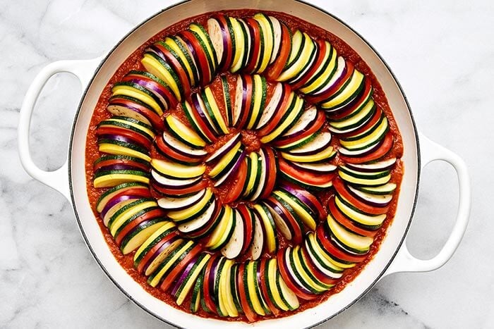 Prepping ratatouille in a pan.