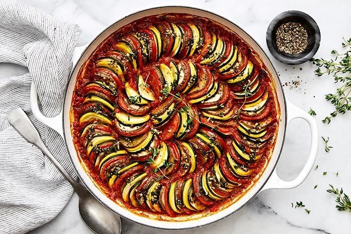 Baked ratatouille in a white pan.