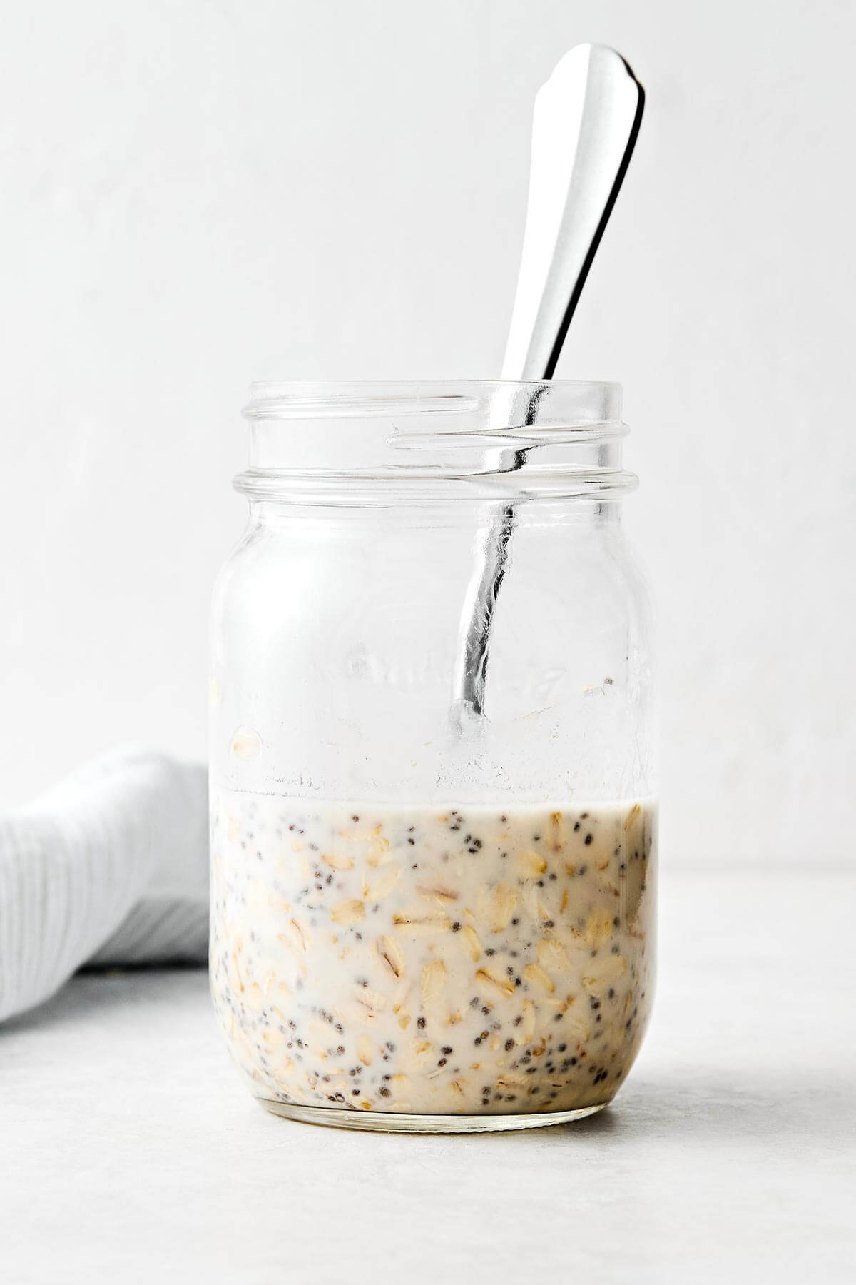 Learn how to make the perfect batch of overnight oats! This version is made with rolled oats, Greek yogurt, milk, chia seeds, and maple syrup for a deliciously ultra-creamy base. Plus, I'll show you how to make 6 different flavors using all the best fruits, including a strawberry protein flavor for an extra protein boost. Save this Downshiftology overnight oats recipe for inspiration when you're looking for an easy, healthy, no-cook breakfast meal prep. Mixed overnight oats in a jar.