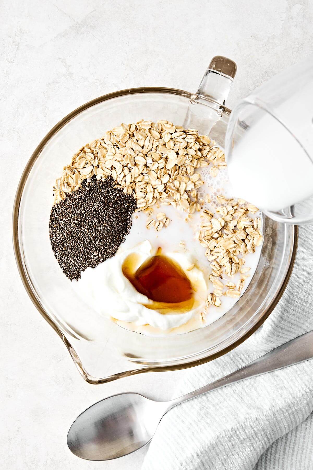 Learn how to make the perfect batch of overnight oats! This version is made with rolled oats, Greek yogurt, milk, chia seeds, and maple syrup for a deliciously ultra-creamy base. Plus, I'll show you how to make 6 different flavors using all the best fruits, including a strawberry protein flavor for an extra protein boost. Save this Downshiftology overnight oats recipe for inspiration when you're looking for an easy, healthy, no-cook breakfast meal prep. Making a large batch of overnight oats.