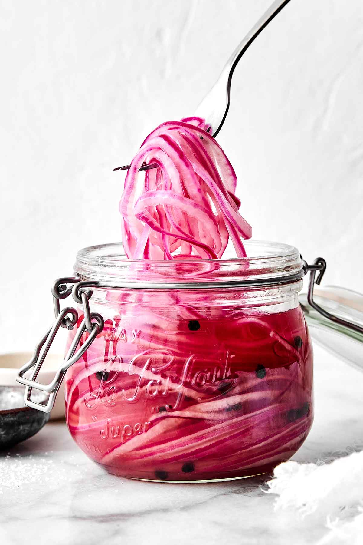 A jar of these pickled red onions is one of the easiest ways to instantly upgrade a meal! They’re tangy, slightly sweet, and extra punchy. Quick pickled red onions in a jar.