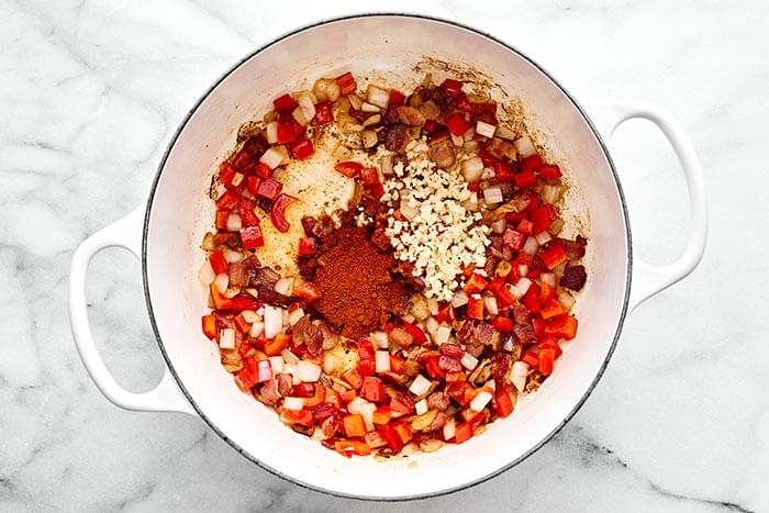 Cooking aromatics in a pot.