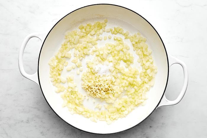 Cooking garlic and onions in a pan.