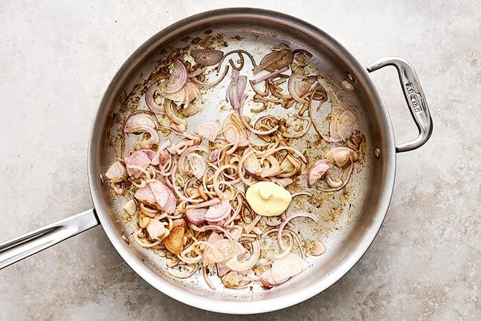 Cooked shallots in a pan.