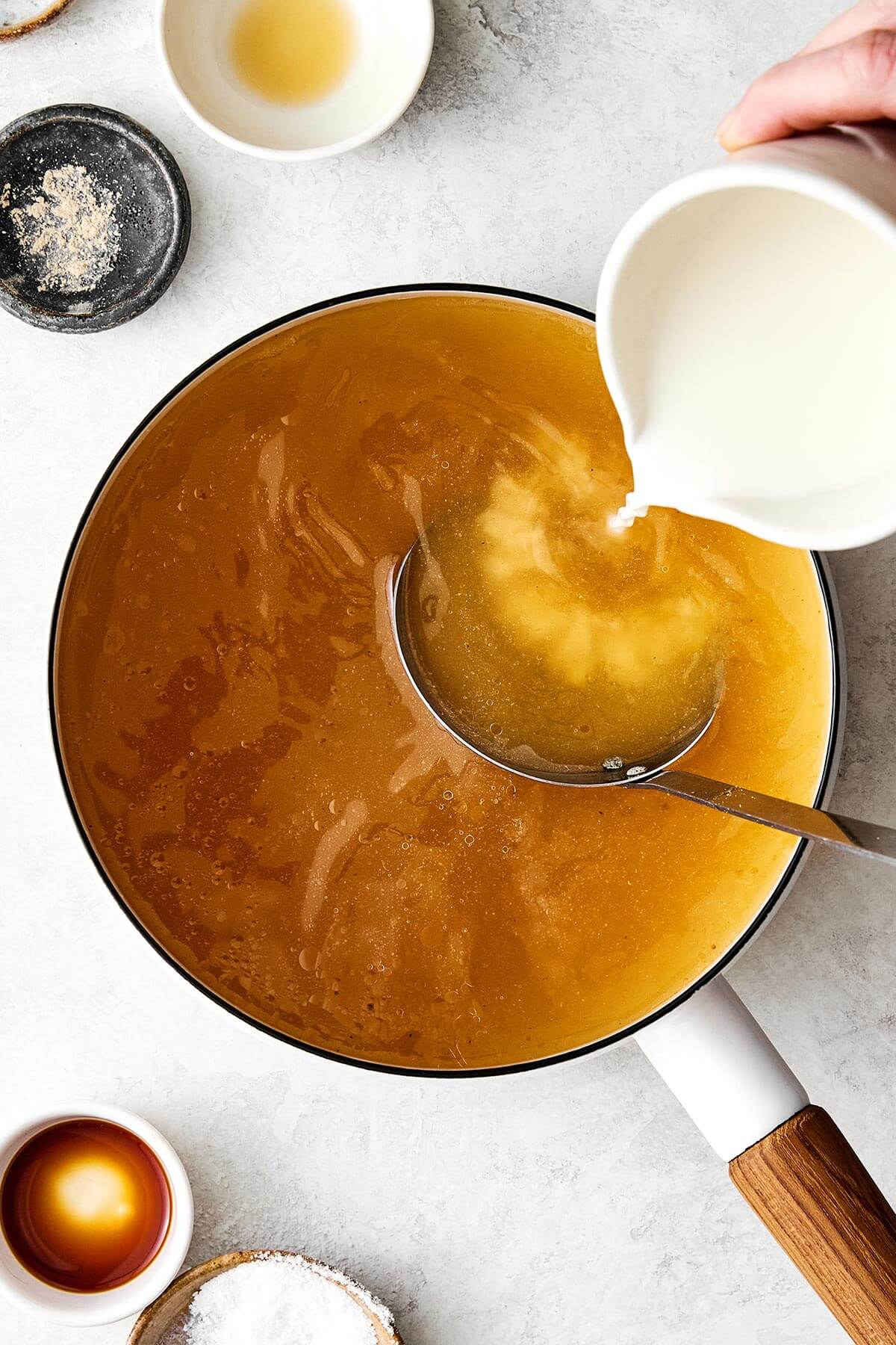 Adding slurry into a pot of broth.
