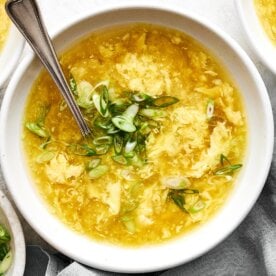 Bowl of egg drop soup and green onion.
