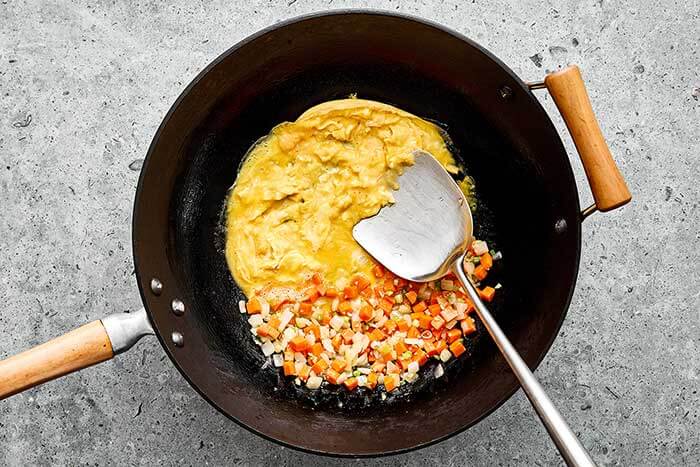 Vegetables and eggs in a wok.