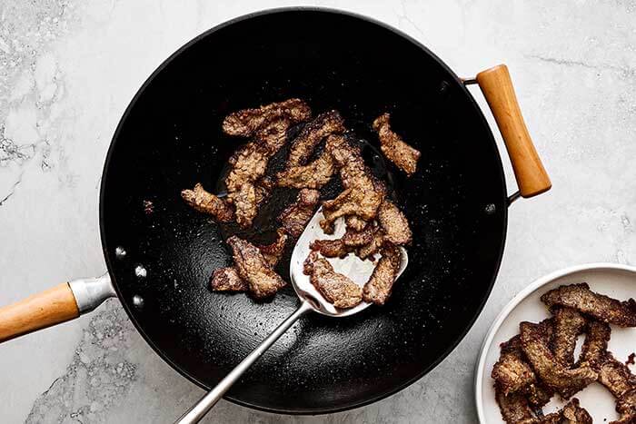 Cooked steak in a wok.