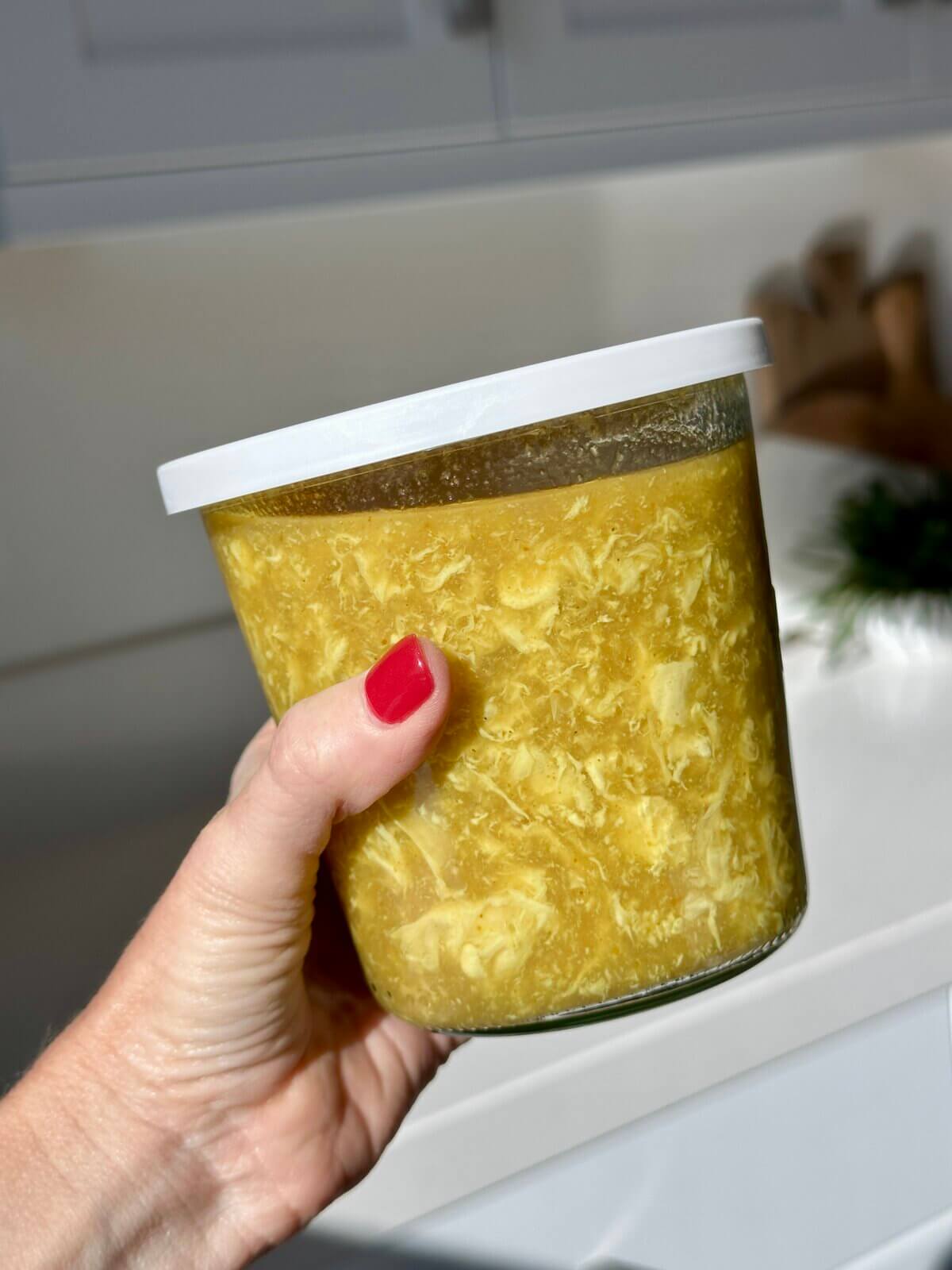 Egg drop soup in a storage container.