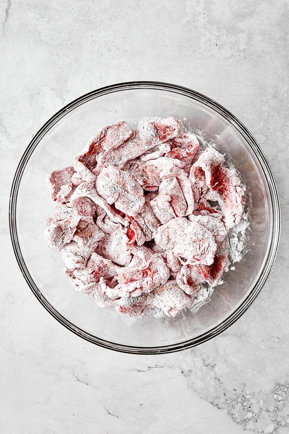Steak slices coated in cornstarch.