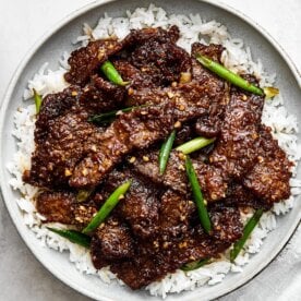 A plate of Mongolian beef with rice.