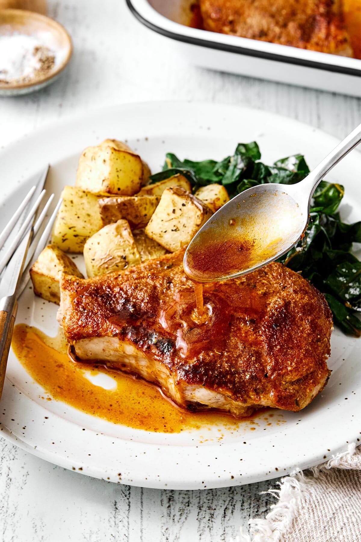Baked pork chops with roasted potatoes.