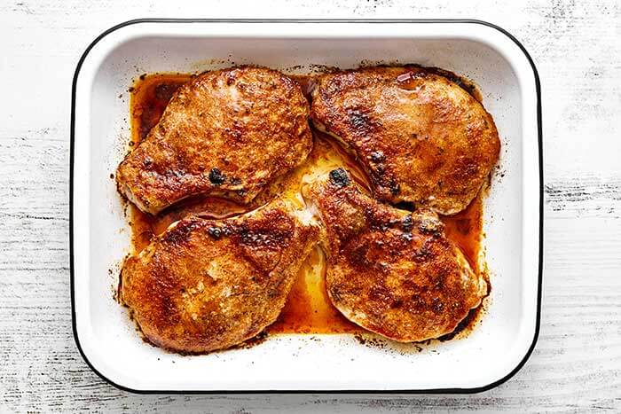 A baking dish of baked pork chops.