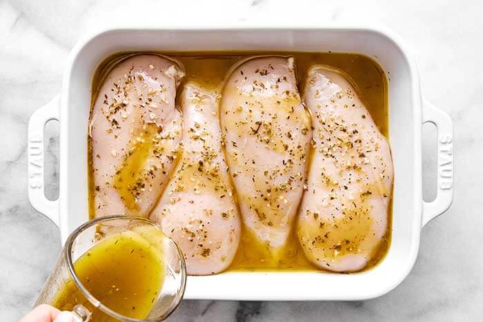 Marinated chicken breasts in a dish.