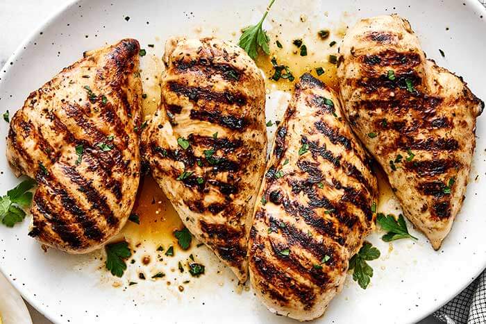 A plate of grilled chicken breasts.