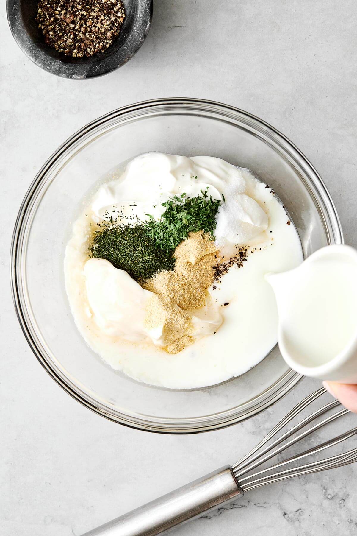 Mixing ranch dressing ingredients.