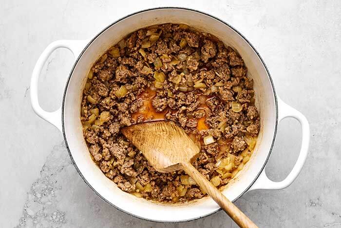 Cooking sausage in a pot.