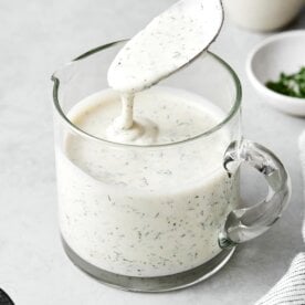 A glass jar of homemade ranch dressing.