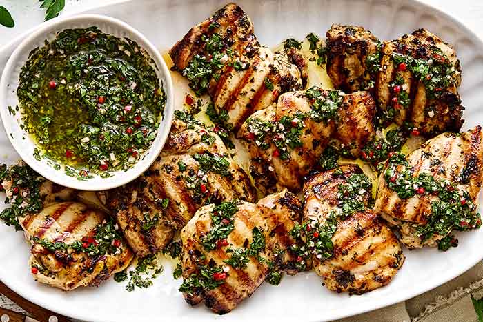 A platter of grilled chimichurri chicken thighs.