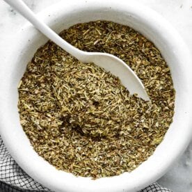 A white bowl of homemade Italian seasoning.