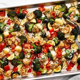A sheet pan dinner of Italian chicken breast and veggies.