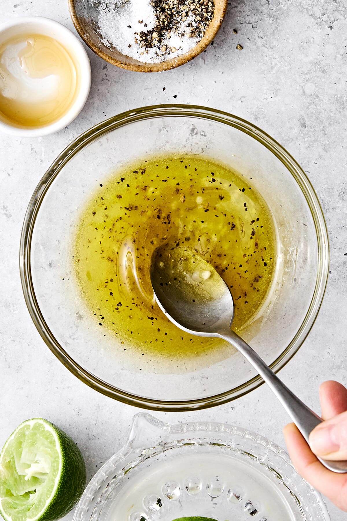This mango avocado shrimp salad is sweet, crunchy, and tossed in a fresh honey lime dressing. It's the ultimate refreshing summer salad! Honey lime dressing in a bowl.